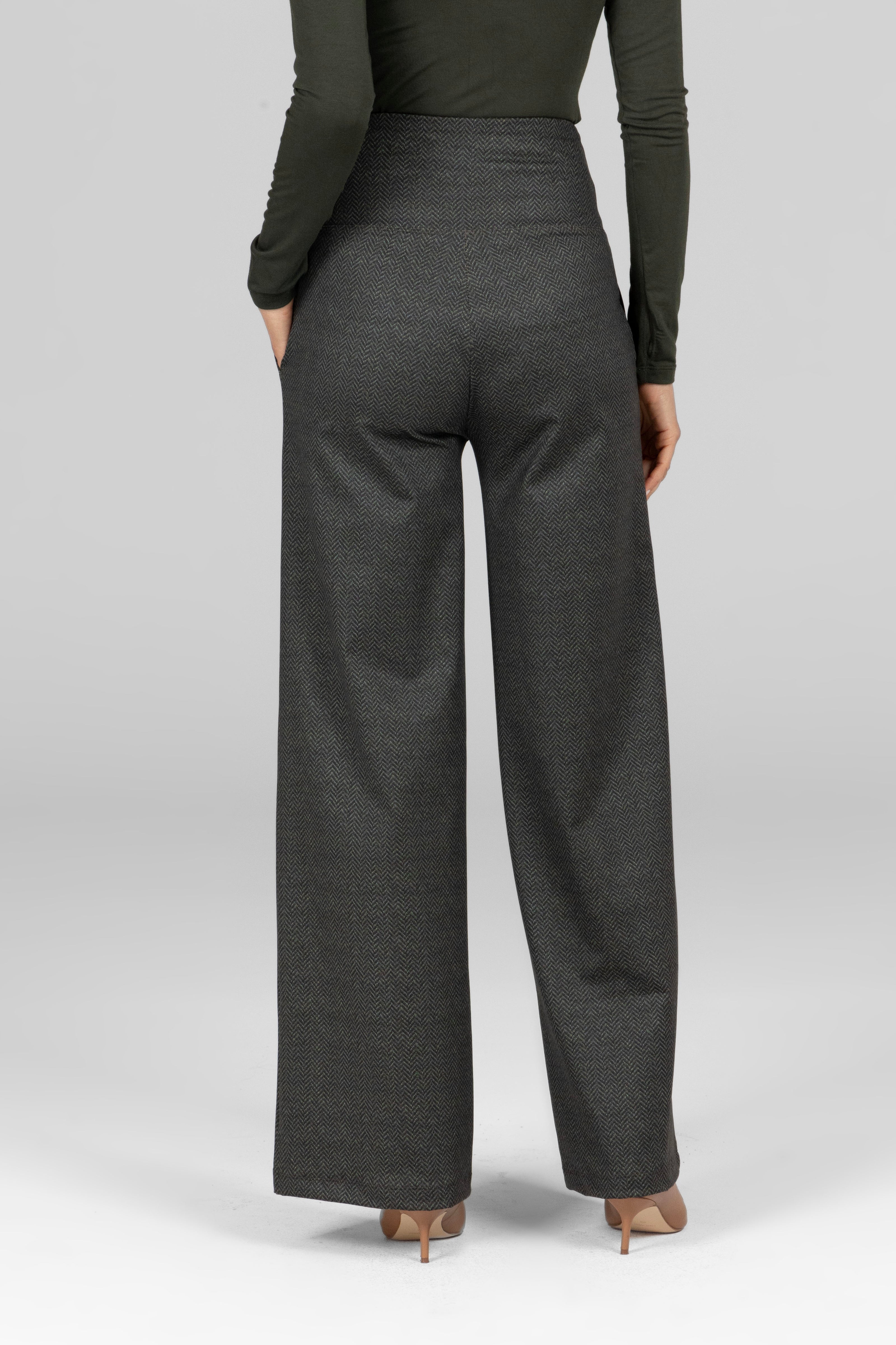 Person wearing dark gray wide-leg pants on a light gray background