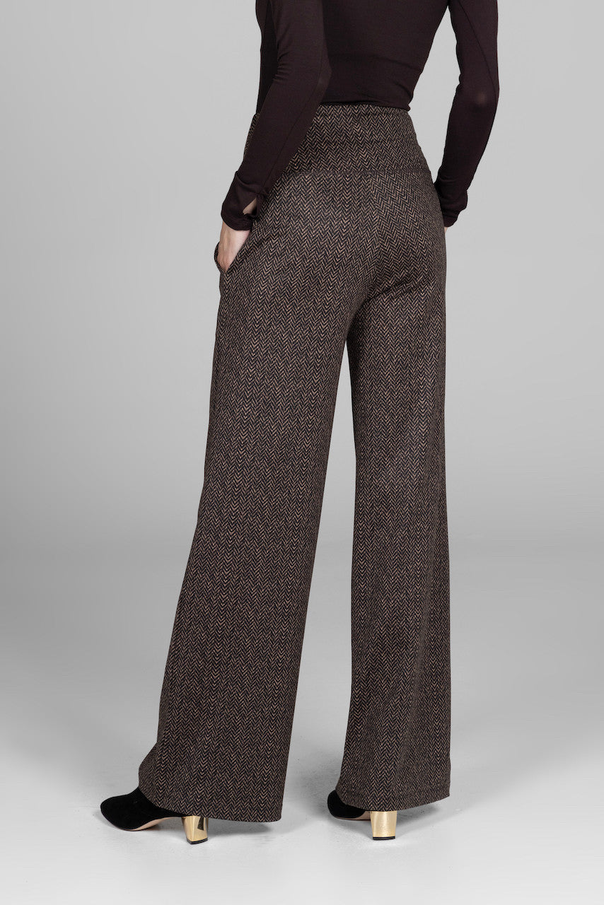 Back view of woman wearing brown herringbone print high waist wide leg pants