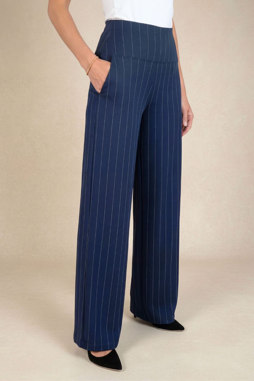 Person wearing blue pinstripe pants on a beige background