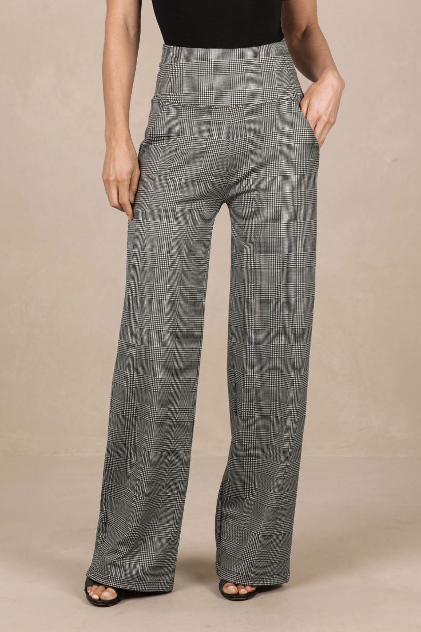 Person wearing high-waisted plaid pants on a beige background