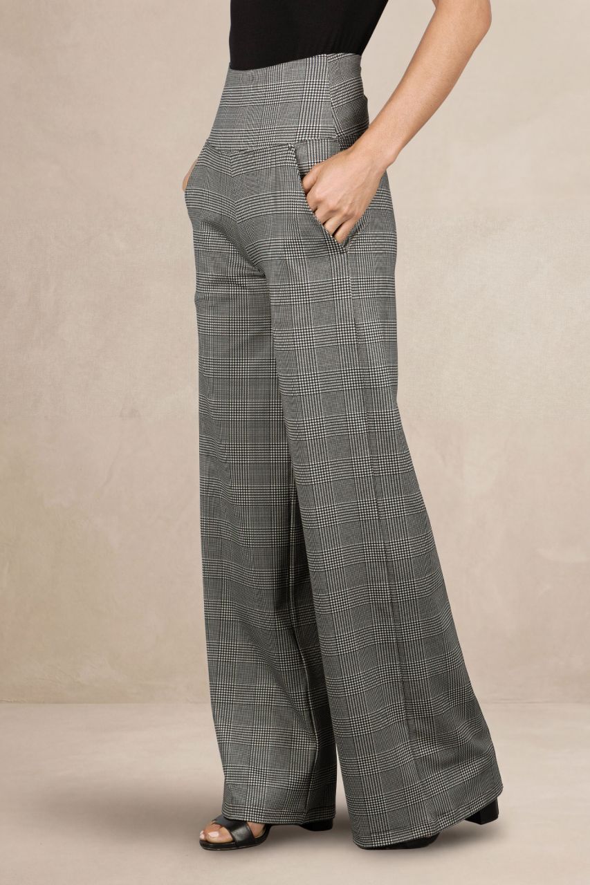 Person wearing gray plaid wide-leg pants on a beige background