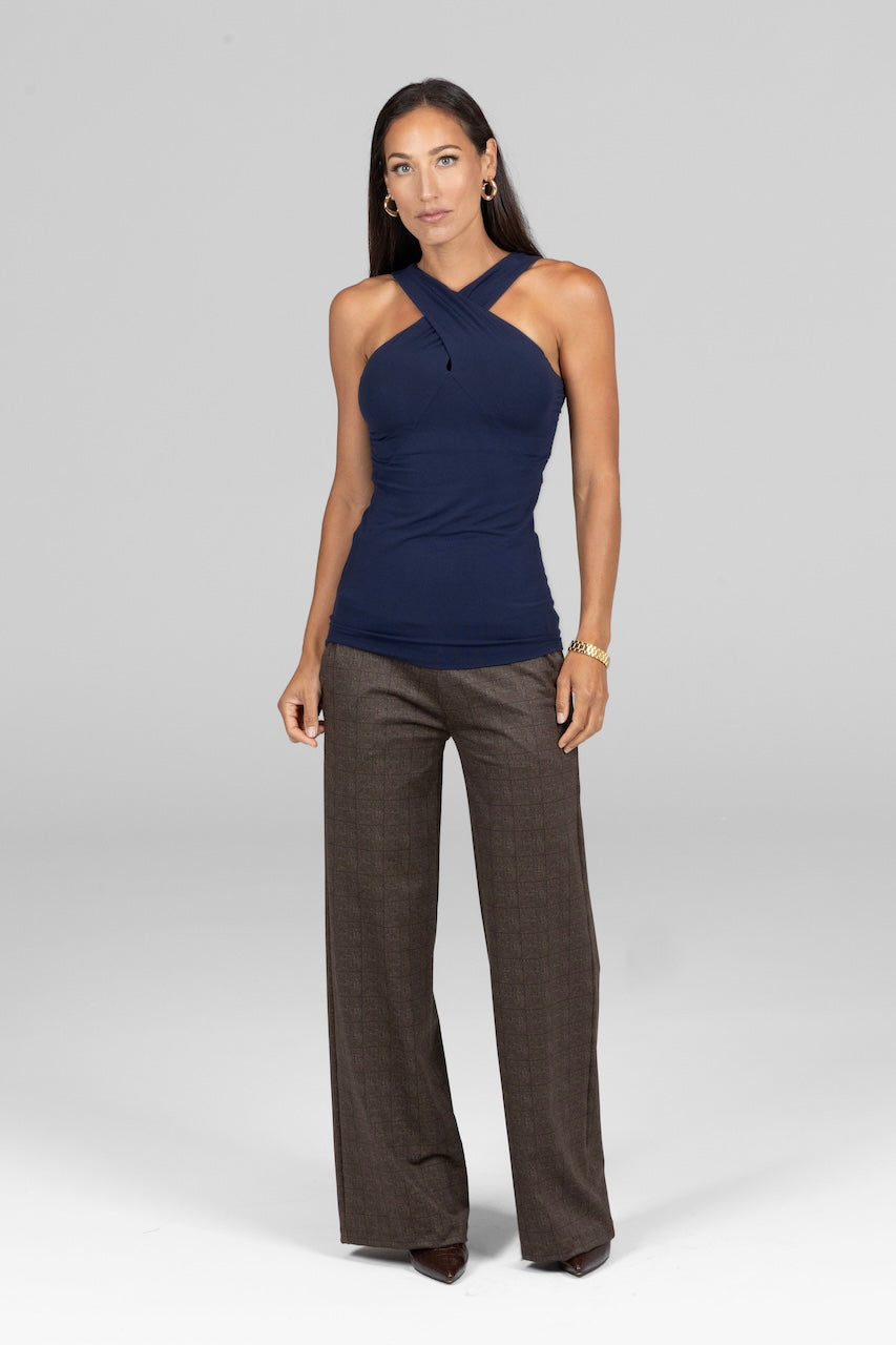 Woman wearing navy halter top paired with brown plaid pants