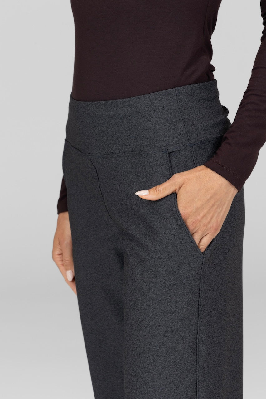 Close up view of woman wearing grey pants with pockets