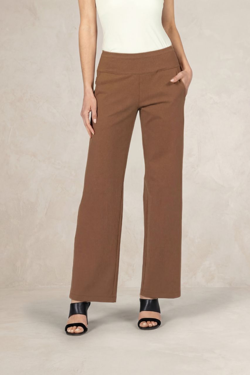 Brown pants worn by a person on a beige background