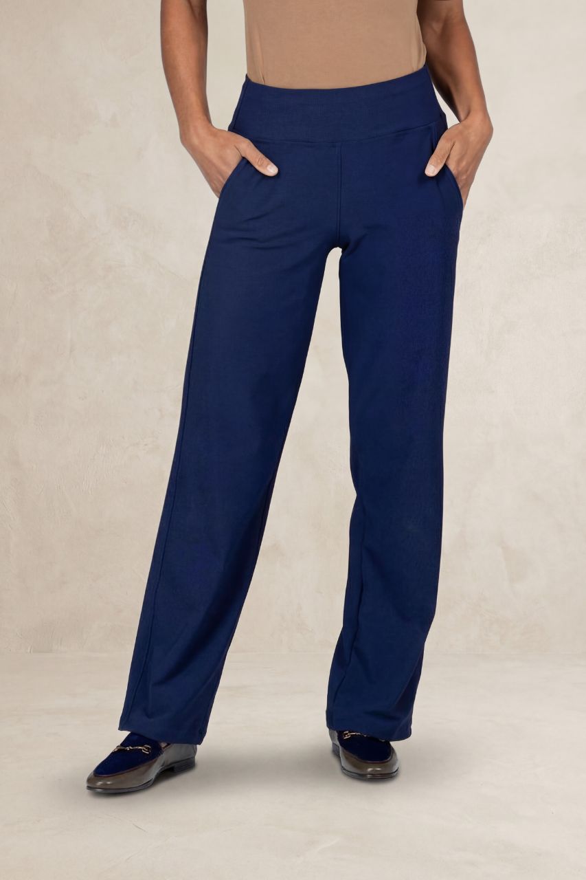 Person wearing blue pants on a beige background