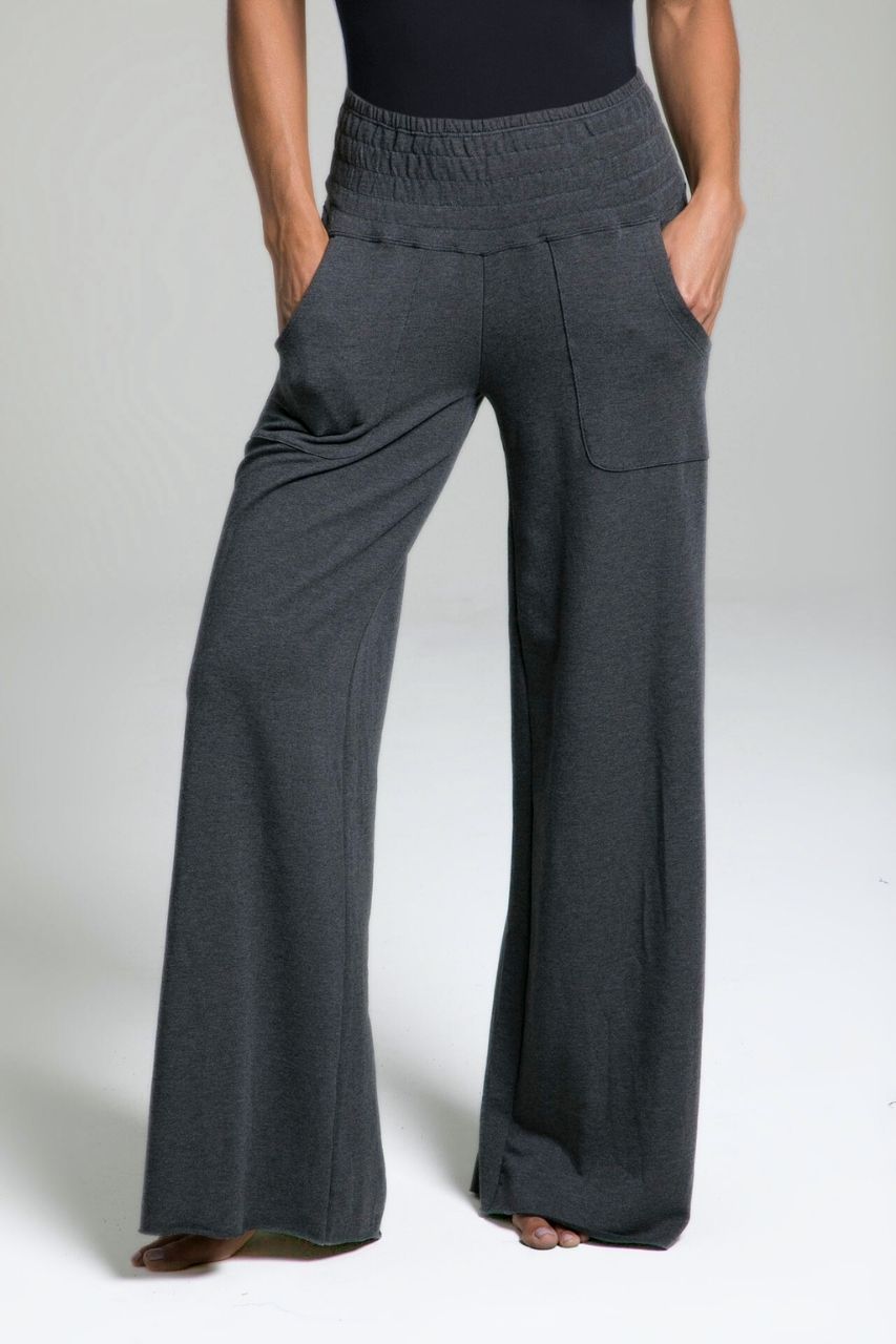 Gray wide-leg lounge pants worn by a woman on a plain background