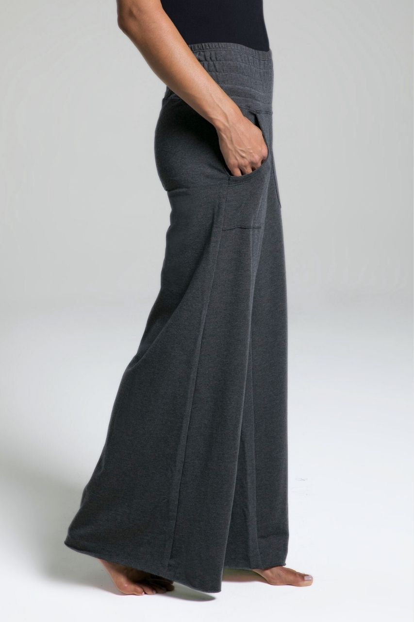 Woman wearing dark gray wide-leg lounge pants on a white background