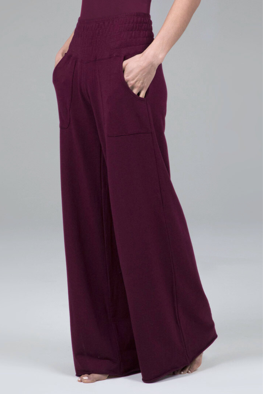 Burgundy wide-leg pants on a plain background