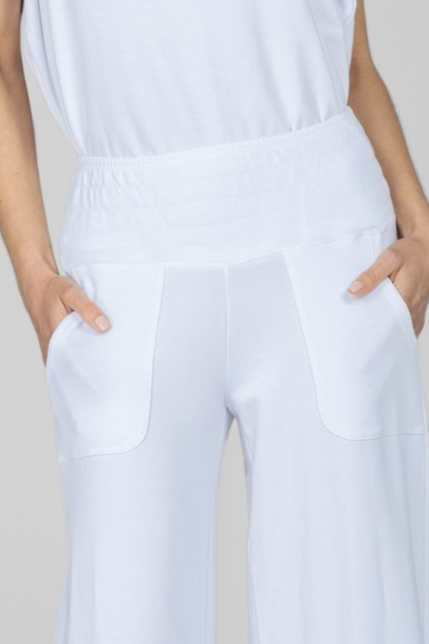 Close up of woman wearing white pants with smocked waistband