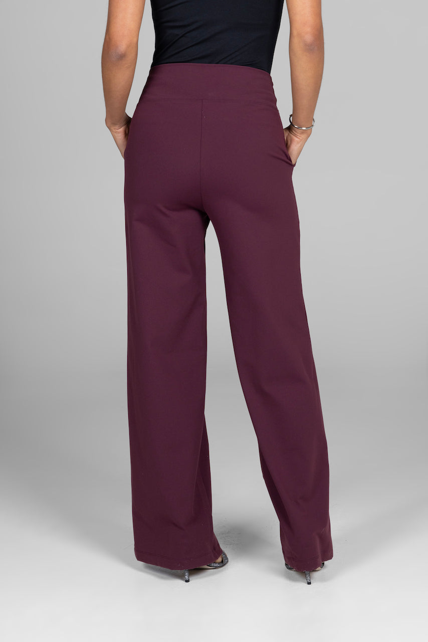 Back view of a woman wearing burgundy wide leg pants