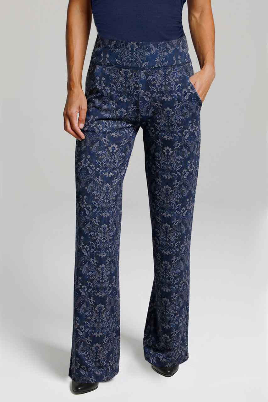 Navy blue floral-patterned high waisted pants worn by a person on a light gray background