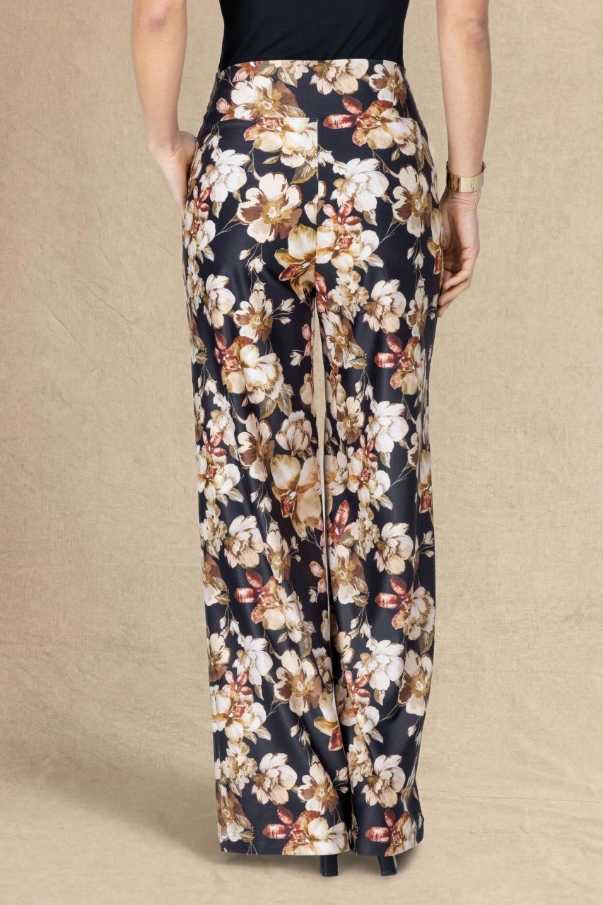 Back view of fall floral pants on a beige background
