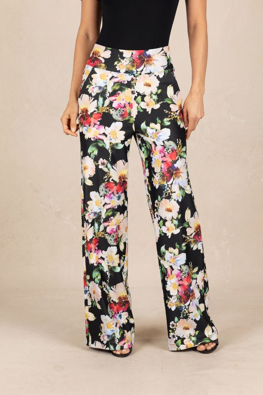 Floral pants worn by a person on a beige background