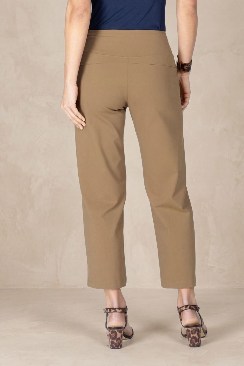 Person wearing beige pants on a plain background