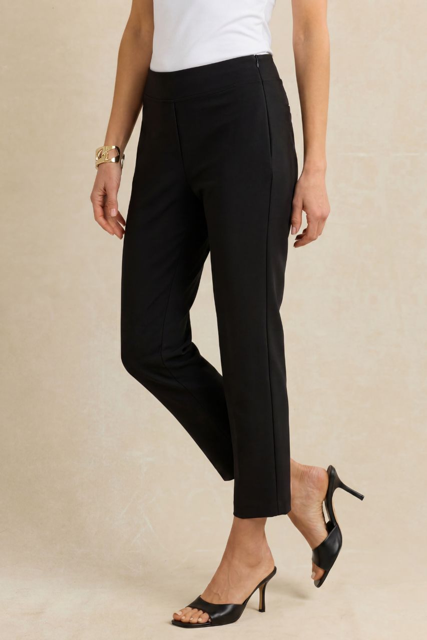Black ankle pants worn by a woman on a beige background