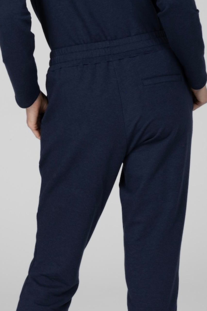 Back close up view of woman wearing navy joggers
