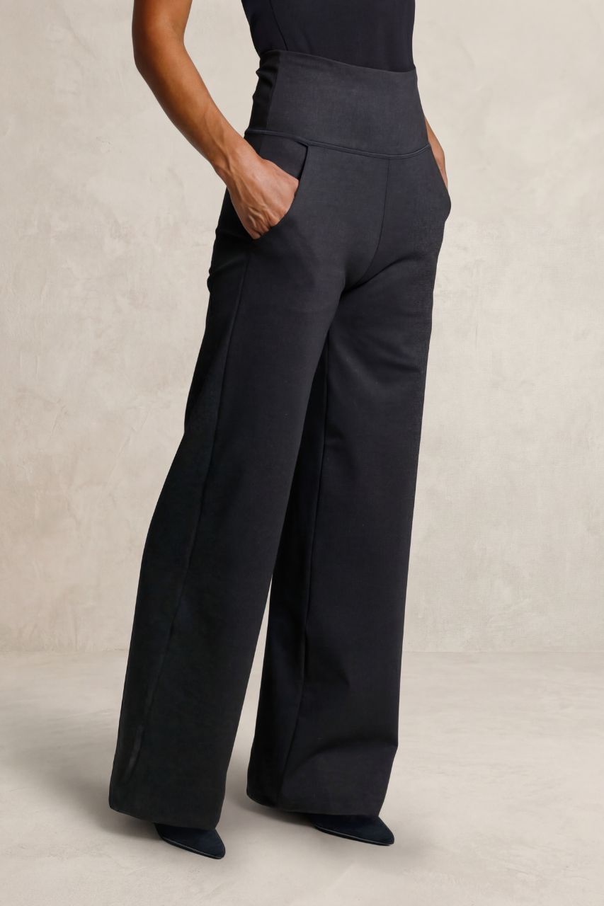 Charcoal wide-leg pants worn by a person on a neutral background
