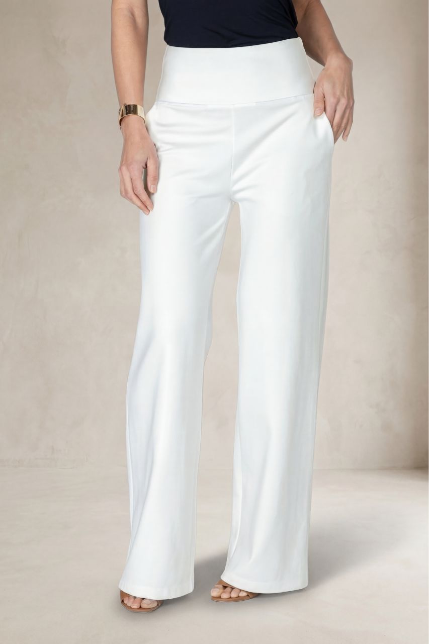White wide-leg pants worn by a person on a beige background