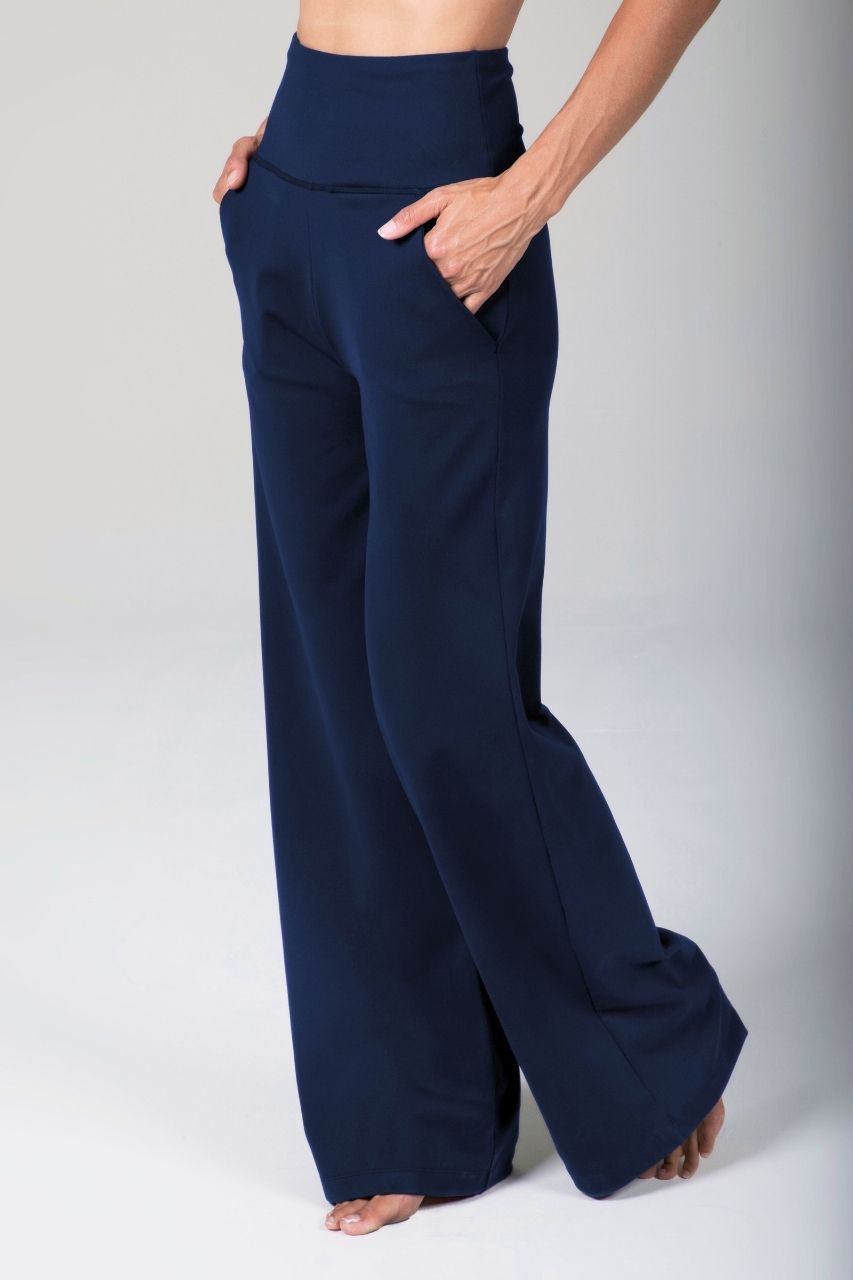 Navy blue wide-leg pants worn by a woman on a white background