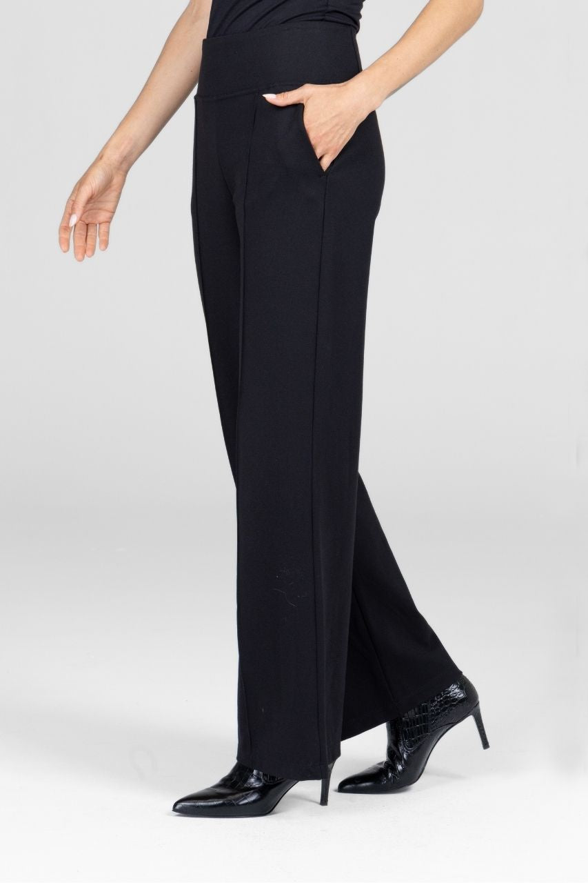 Woman wearing black wide-leg pants on a white background