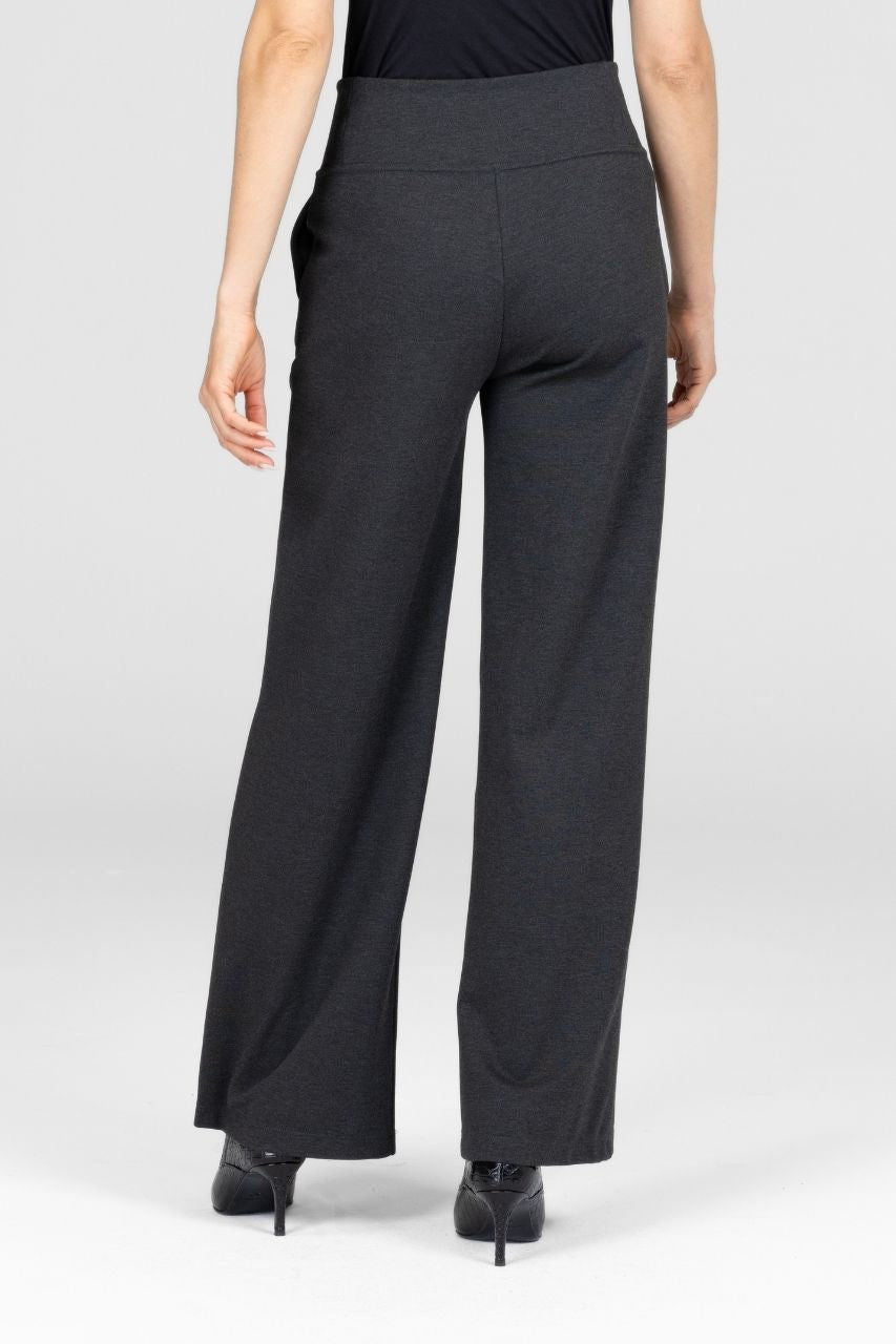 Back view of a woman wearing dark gray high waist wide-leg pants worn by a person on a white background