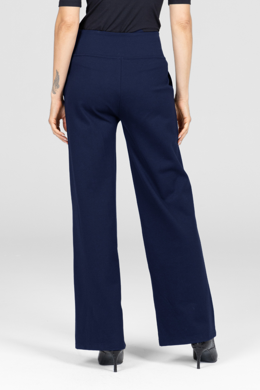 Back view navy blue wide leg pants worn by a woman on a white background