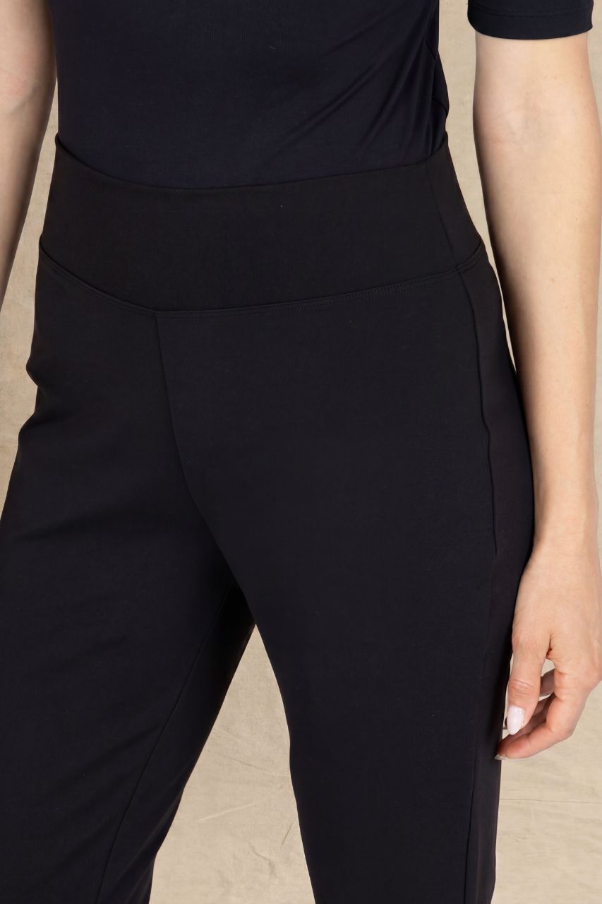 Close up view of a woman wearing black pants