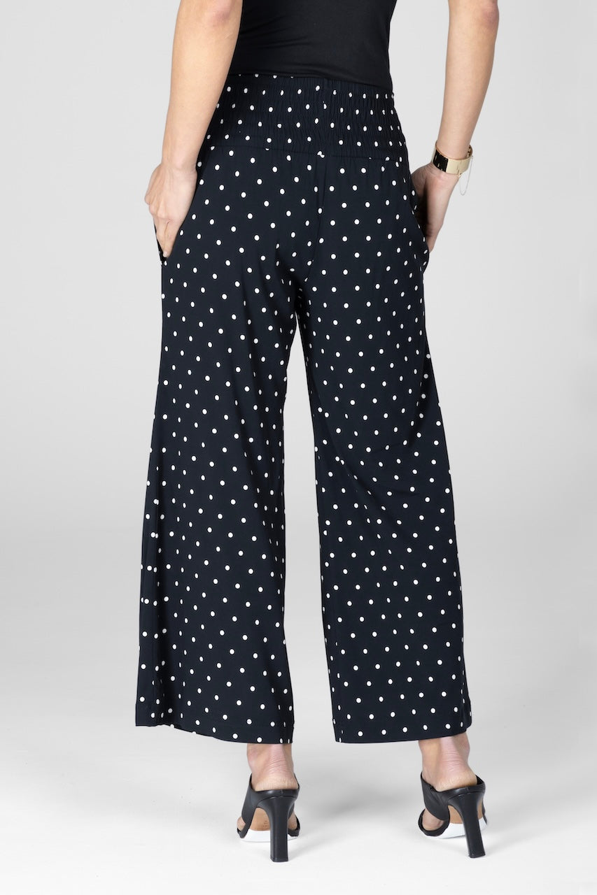 Back view of woman wearing black dot ankle pants