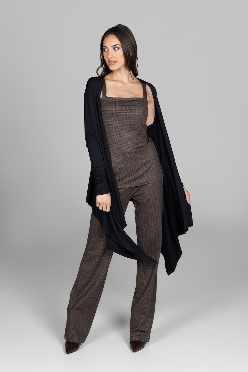 Woman wearing black cardigan over a brown plaid matching set