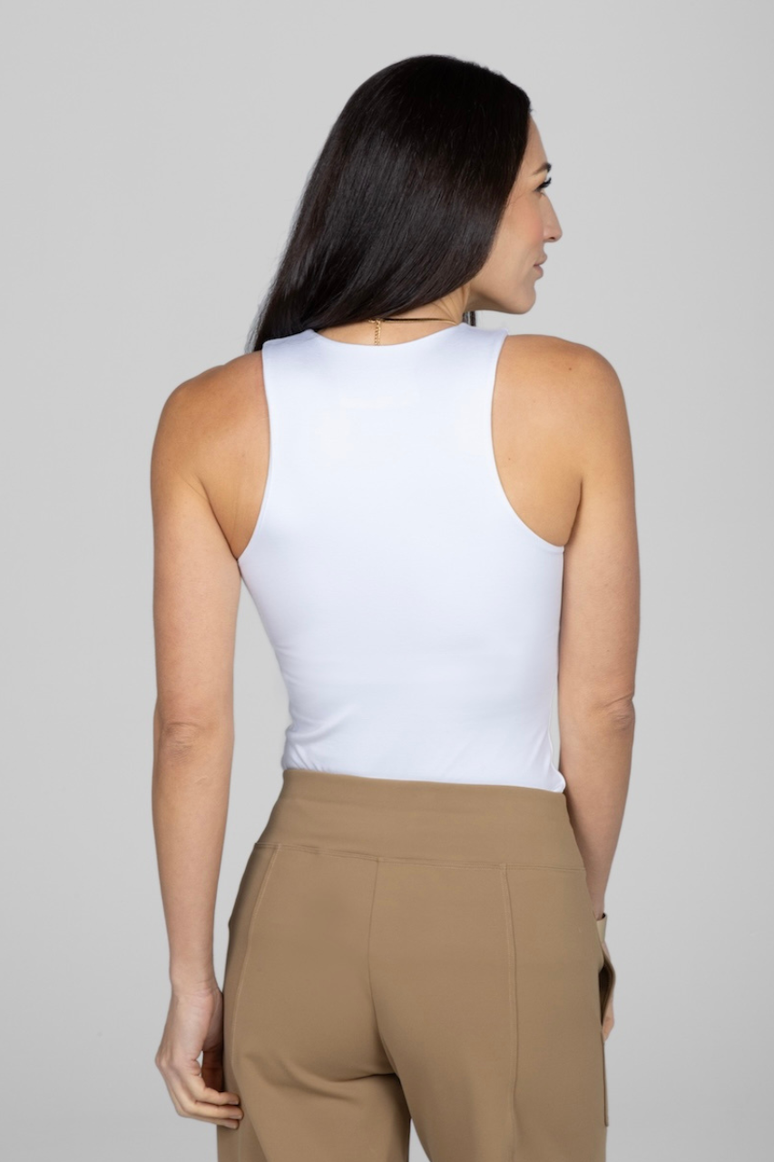 Back view of woman wearing white tank top