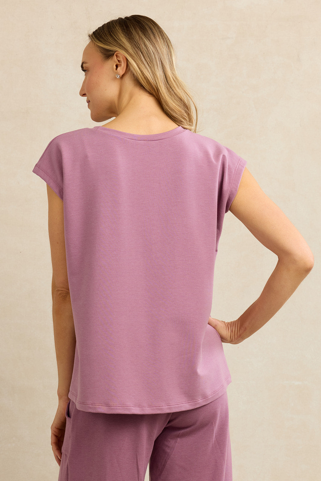 Back view of a woman wearing pink dolman top
