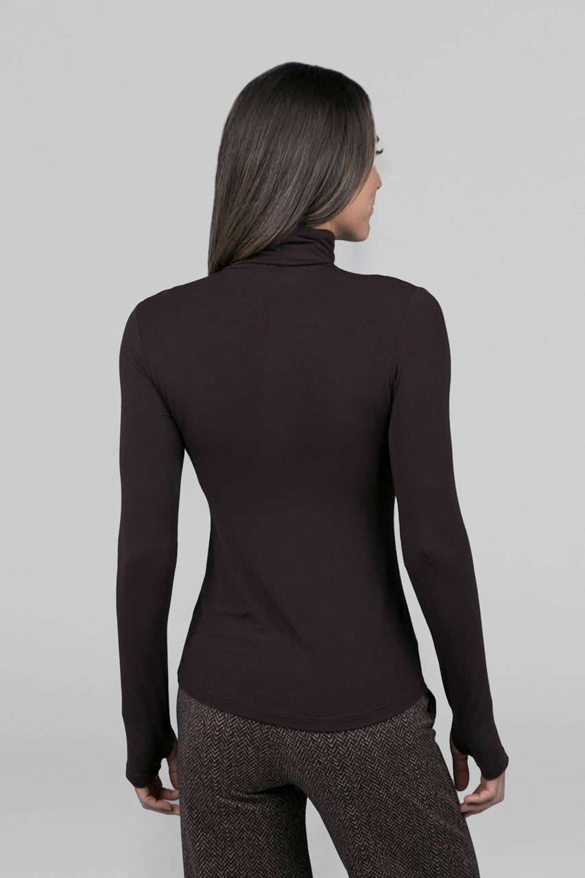 Back view of woman wearing brown long sleeve turtleneck