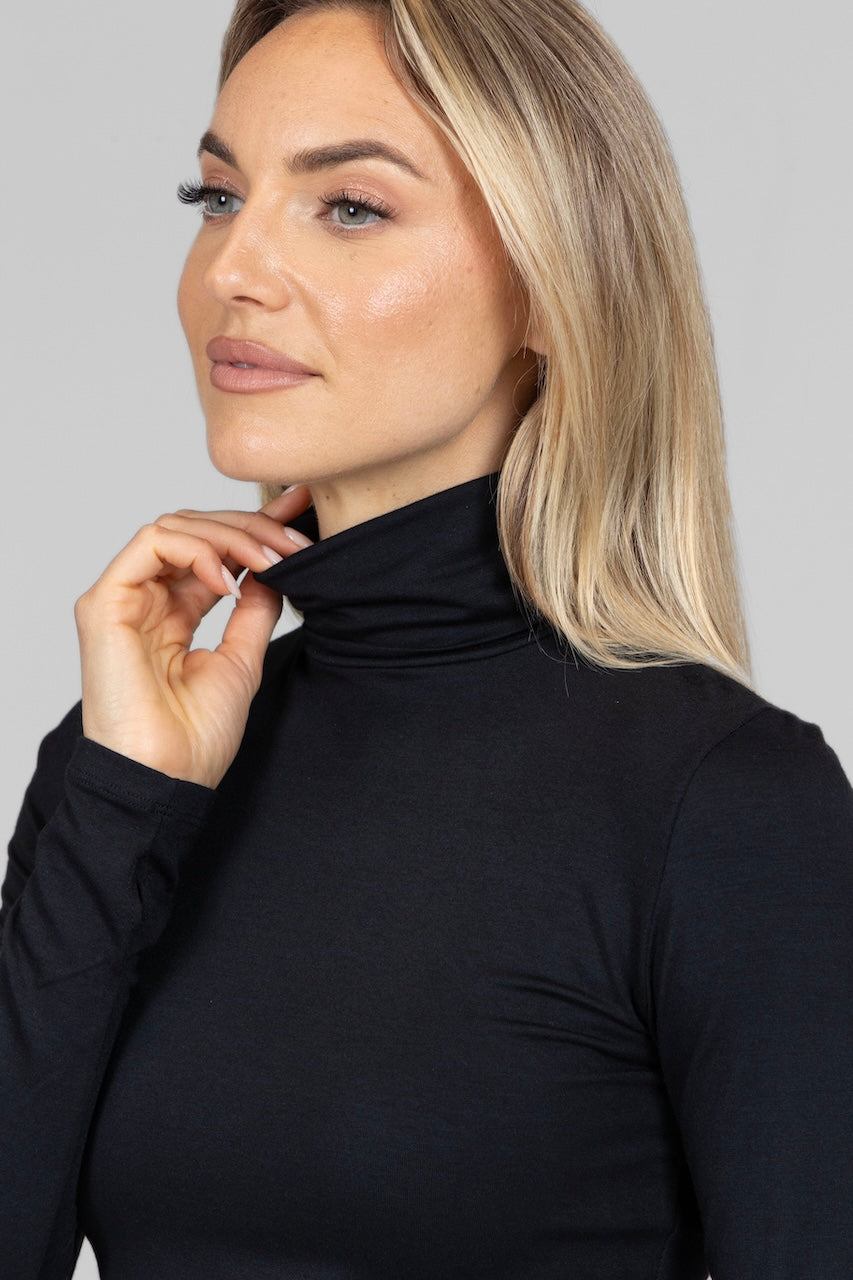 Close up photo of a woman wearing a black turtleneck