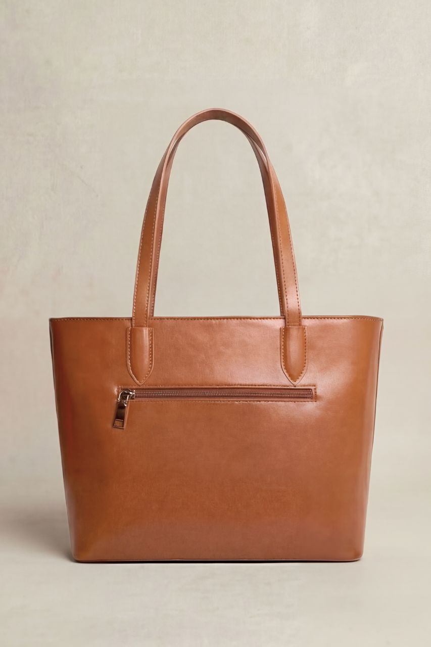 Back view of a brown PU leather tote bag on a beige background