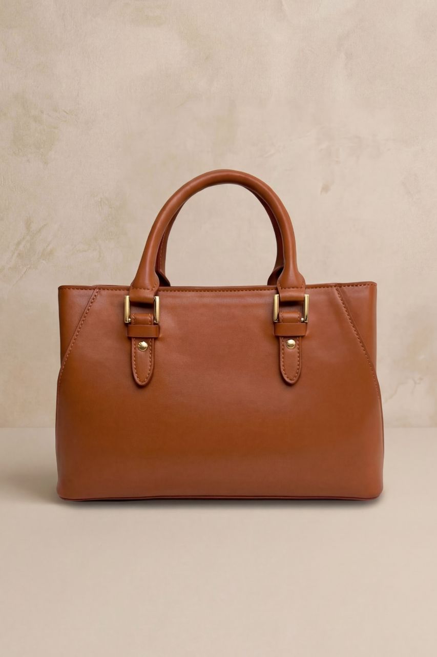 Brown PU leather handbag on a beige background