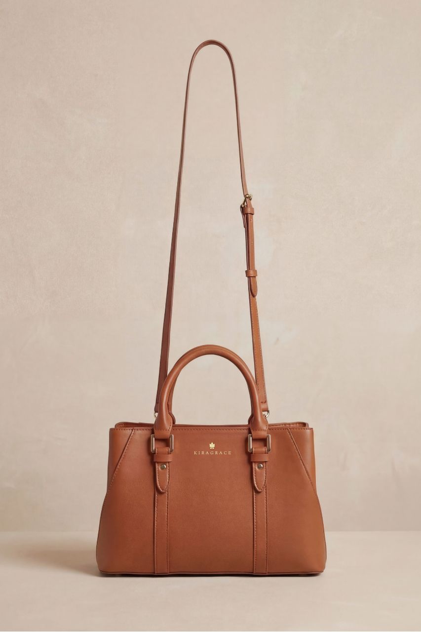 Brown handbag with a strap on a beige background