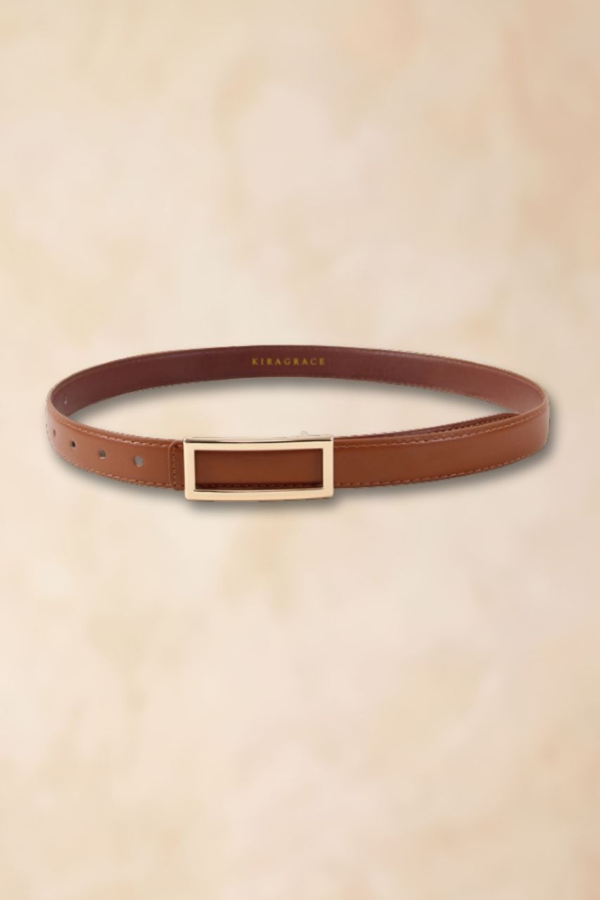 Brown leather belt with gold buckle on a beige background