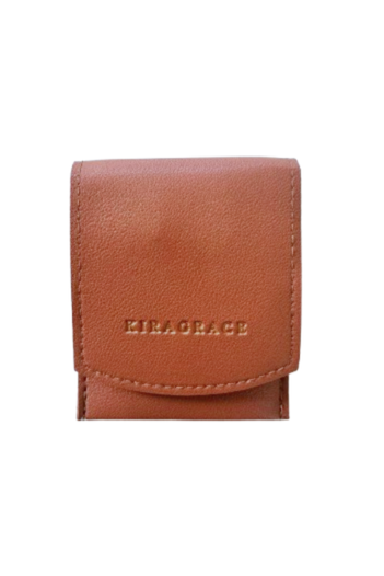 A brown leather travel manicure kit with the brand name KIRAGRACE embossed on it.