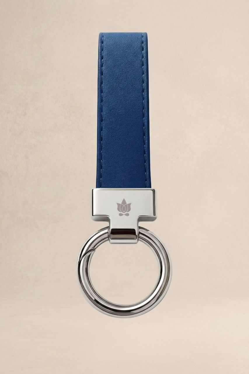 Dark blue KiraGrace keychian on a beige background