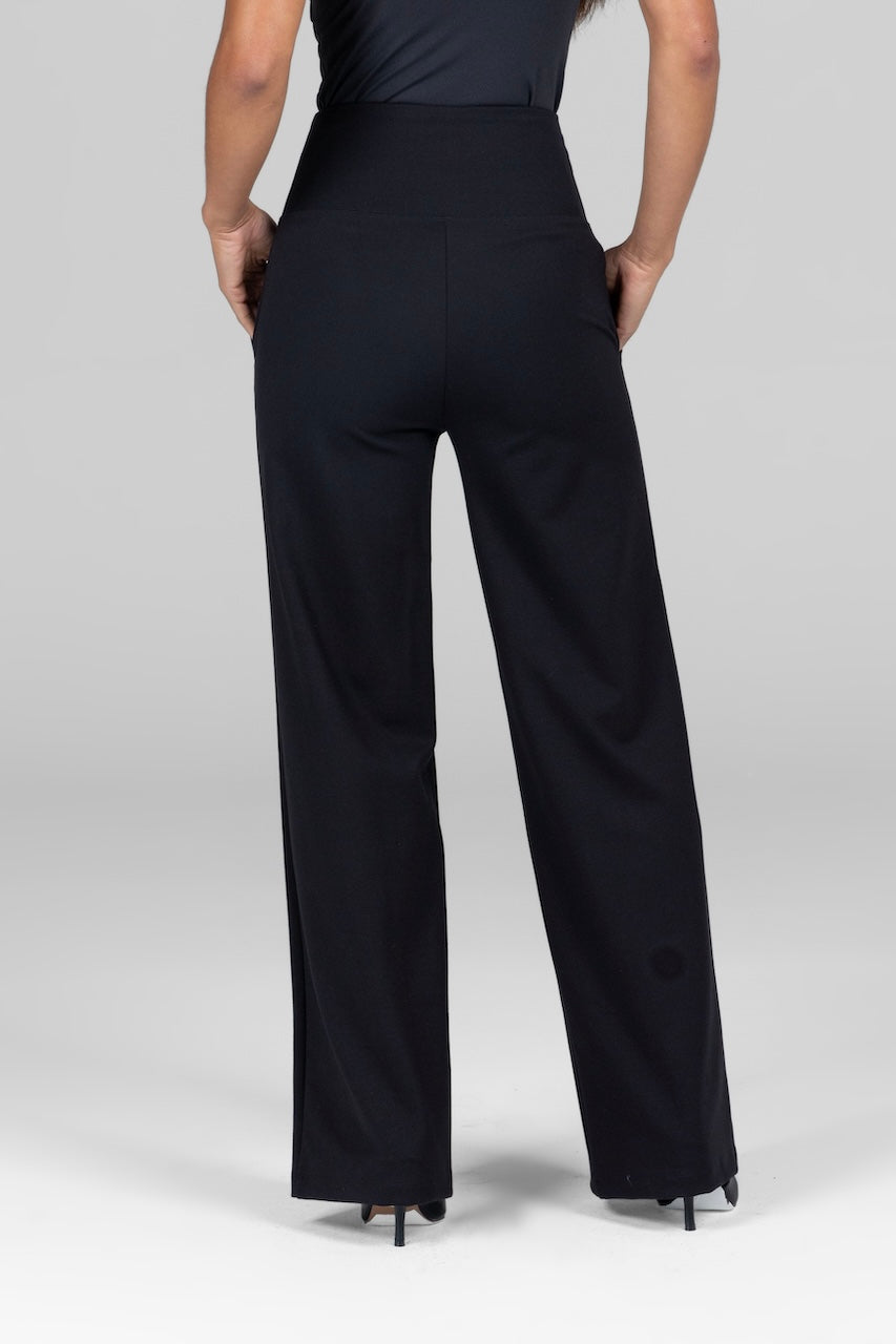 Back view of a woman, wearing black high-waist, wide-leg ponte pants. The pants have a clean, smooth design with a fitted waistline that extends into flowy, wide legs.