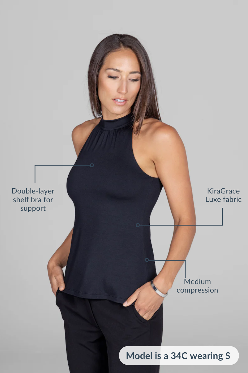 Woman wearing black mock neck hatler with attributes: Double-layer shelf bra, KiraGrace Luxe fabric, and medium compression