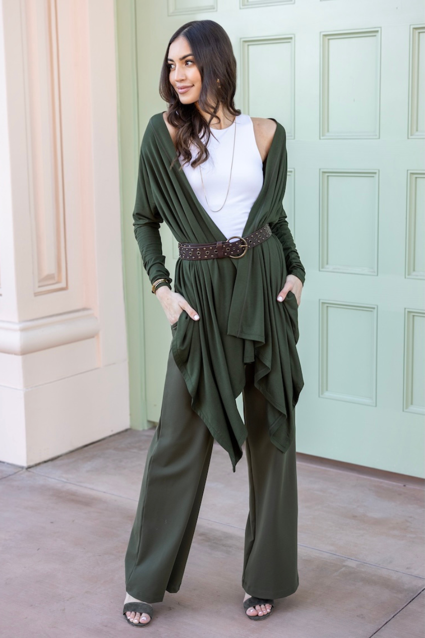 Woman wearing green cardigan and green wide leg pants layered on top of a white tank top