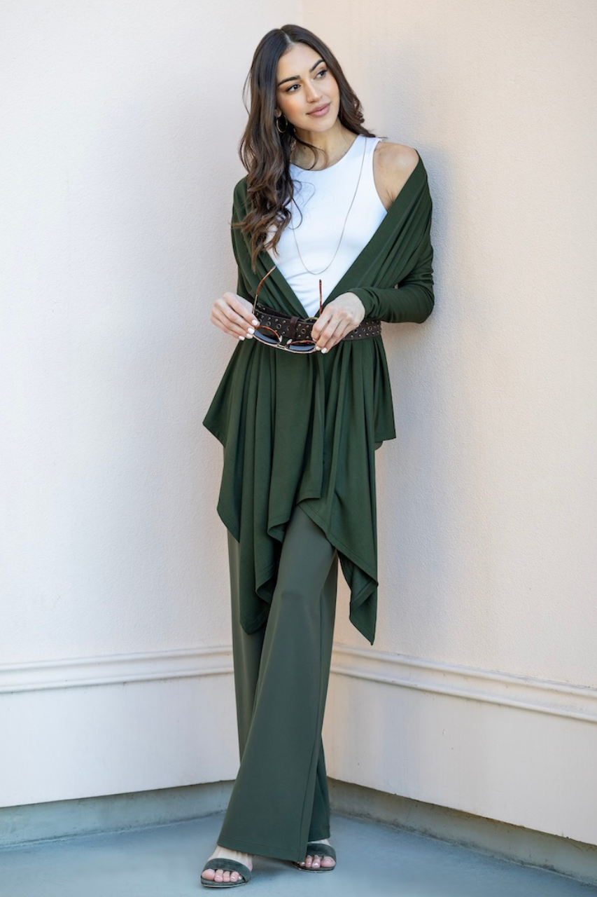 Model wearing white tank top layered with forest green wrap cardigan and matching high waist wide leg pants.