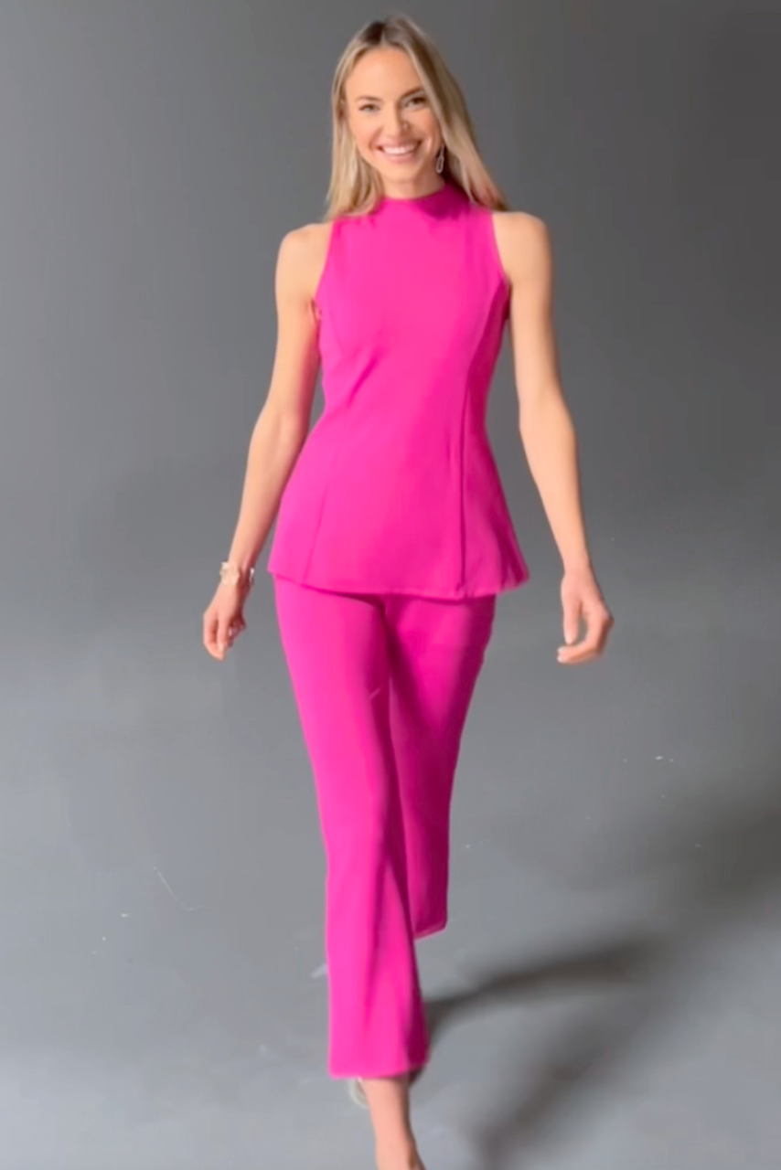Video of model wearing matching hot pink work outfit and posing for the camera