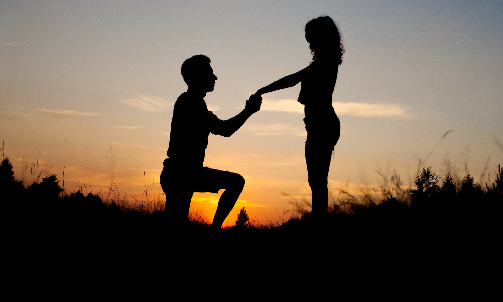 Couple at sunset during a proposal