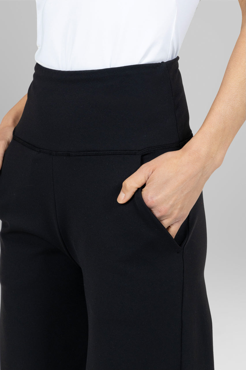 Close-up of black wide-leg pants waistband and pocket detailing.