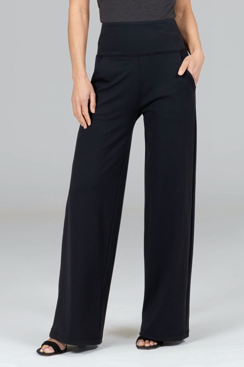 Black high waist wide-leg pants worn by a woman on a plain background