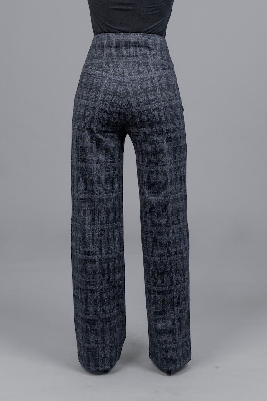 Back view of woman wearing high waisted wide leg grey plaid pants

