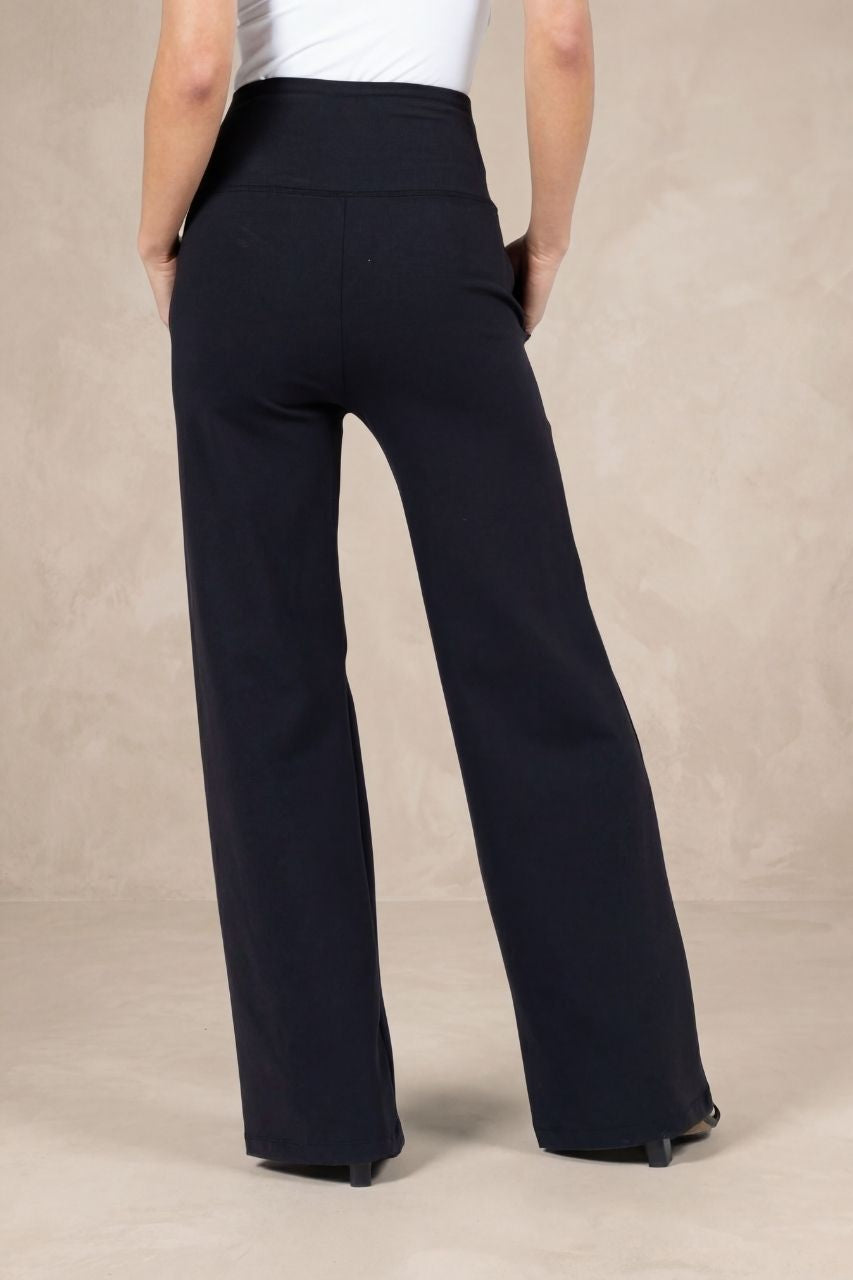 Back view of a woman wearing black high waist wide leg pants