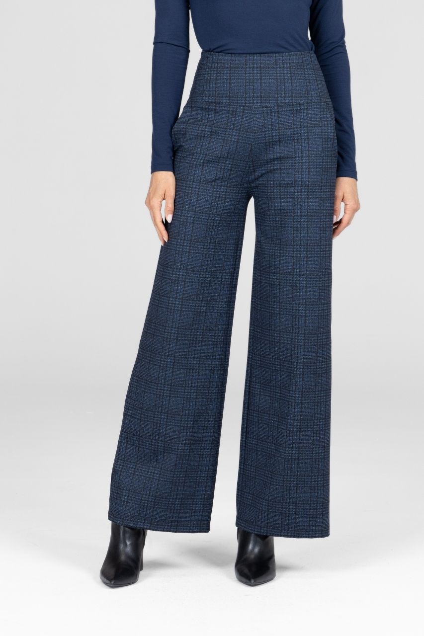 Woman wearing blue plaid wide leg pants and a matching top on a white background